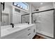 Modern bathroom with white cabinets, quartz countertops, and walk-in shower at 3021 Isaac River Dr, Las Vegas, NV 89134