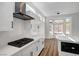 Modern kitchen with white cabinets, black appliances, and quartz countertops at 3021 Isaac River Dr, Las Vegas, NV 89134