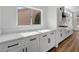 White kitchen cabinets and countertops with black hardware at 3021 Isaac River Dr, Las Vegas, NV 89134