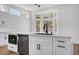 Kitchen island with sink, dishwasher, and white cabinetry at 3021 Isaac River Dr, Las Vegas, NV 89134