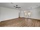 Bright living room with wood-look floors and ceiling fan at 3021 Isaac River Dr, Las Vegas, NV 89134