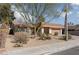 House with desert landscaping and a large tree in the front yard at 3126 Cabachon Ave, Las Vegas, NV 89121