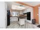 White kitchen with black appliances and an island at 3126 Cabachon Ave, Las Vegas, NV 89121