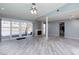 Living room with wood-look floors, fireplace, and access to backyard pool at 3126 Cabachon Ave, Las Vegas, NV 89121