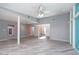 Spacious living room with light gray wood-look floors and a ceiling fan at 3126 Cabachon Ave, Las Vegas, NV 89121