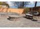 Stone patio with fire pit and wicker furniture at 3126 Cabachon Ave, Las Vegas, NV 89121