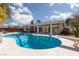 Large kidney shaped pool with diving board and pergola at 3126 Cabachon Ave, Las Vegas, NV 89121