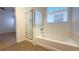 Bright bathroom showcasing a tub-shower combo and natural light from the window at 3317 Barada Heights Ave, North Las Vegas, NV 89081