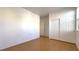 Well-lit bedroom features wood-look floors, a closet with sliding doors, and an open doorway at 3317 Barada Heights Ave, North Las Vegas, NV 89081