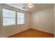 Simple bedroom with wood flooring and window blinds at 3317 Barada Heights Ave, North Las Vegas, NV 89081