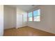 Bedroom showcasing wood-look flooring, closet with sliding doors, and windows for natural light at 3317 Barada Heights Ave, North Las Vegas, NV 89081