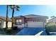 Tan house with tile roof, two-car garage, and desert landscaping at 3317 Barada Heights Ave, North Las Vegas, NV 89081