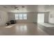 Bright and spacious living room featuring tile and laminate flooring, recessed lighting, and large windows at 3317 Barada Heights Ave, North Las Vegas, NV 89081