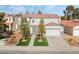 Two-story house with artificial turf, two-car garage, and solar panels on neighboring houses at 3728 Shimmering Creek Ave, North Las Vegas, NV 89031