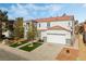 Two-story house with artificial turf, two-car garage, and solar panels at 3728 Shimmering Creek Ave, North Las Vegas, NV 89031