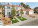 Two-story house with artificial turf, two-car garage, and solar panels on neighboring houses at 3728 Shimmering Creek Ave, North Las Vegas, NV 89031