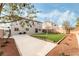 Landscaped backyard with artificial turf and a large concrete patio at 3728 Shimmering Creek Ave, North Las Vegas, NV 89031