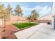 Landscaped backyard with artificial turf and patio at 3728 Shimmering Creek Ave, North Las Vegas, NV 89031