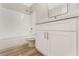 Updated bathroom with white vanity, a tub, and wood flooring at 3728 Shimmering Creek Ave, North Las Vegas, NV 89031