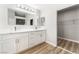 Bright bathroom with double vanity, walk-in closet, and wood-look floors at 3728 Shimmering Creek Ave, North Las Vegas, NV 89031