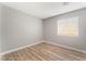 Simple bedroom with light gray walls and wood flooring at 3728 Shimmering Creek Ave, North Las Vegas, NV 89031