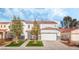 Two-story house with a white exterior, two-car garage, and landscaped front yard at 3728 Shimmering Creek Ave, North Las Vegas, NV 89031