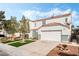 Two-story house with a white exterior, two-car garage, and landscaped front yard at 3728 Shimmering Creek Ave, North Las Vegas, NV 89031