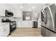 Modern kitchen with white cabinets, stainless steel appliances, and quartz countertops at 3728 Shimmering Creek Ave, North Las Vegas, NV 89031