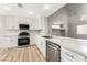 Modern kitchen with white cabinets, quartz countertops, and stainless steel appliances at 3728 Shimmering Creek Ave, North Las Vegas, NV 89031