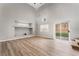 Living room with hardwood floors, built-in shelving, and sliding glass doors to the backyard at 3728 Shimmering Creek Ave, North Las Vegas, NV 89031