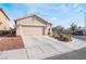 House exterior showcasing a two-car garage and neatly landscaped yard at 3952 Moon Tango St, Las Vegas, NV 89129