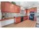 Spacious kitchen with wood cabinets, granite countertops, and stainless steel appliances at 3952 Moon Tango St, Las Vegas, NV 89129