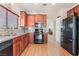 Modern kitchen featuring stainless steel appliances and wood cabinetry at 3952 Moon Tango St, Las Vegas, NV 89129