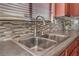 Clean kitchen sink with stainless steel double basin and contemporary faucet at 3952 Moon Tango St, Las Vegas, NV 89129