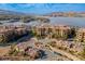 Beautiful lakeside community featuring residences with red-tile roofs, lush greenery, and convenient access to waterfront amenities at 4 Via Centrale # 3, Henderson, NV 89011