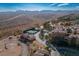 Expansive aerial view showcasing desert landscaping, a tennis court, and beautiful homes nestled against a mountain backdrop at 4 Via Centrale # 3, Henderson, NV 89011