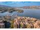 Stunning aerial view of waterfront homes, a marina, and tranquil lake surrounded by mountains in a picturesque community at 4 Via Centrale # 3, Henderson, NV 89011