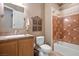 Full bathroom featuring a shower-tub combo with decorative tile surround, complemented by a granite-topped vanity and classic fixtures at 4 Via Centrale # 3, Henderson, NV 89011