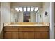 Bathroom featuring double sinks, vanity, large mirror, and view into the bedroom at 4 Via Centrale # 3, Henderson, NV 89011