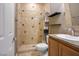 Cozy bathroom featuring shower with decorative tiling, a toilet, and a vanity at 4 Via Centrale # 3, Henderson, NV 89011