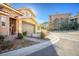 Two-story home with an attached garage, desert landscaping, and an American flag at 4 Via Centrale # 3, Henderson, NV 89011