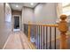 Hallway with wooden railing leading to carpeted stairs at 4 Via Centrale # 3, Henderson, NV 89011