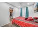 Bedroom with red bedding and teal curtains at 4064 Emerald Wood St, Las Vegas, NV 89115