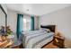 Bedroom with gray bedding and teal curtains at 4064 Emerald Wood St, Las Vegas, NV 89115