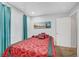 Bedroom with red bedding and teal curtains at 4064 Emerald Wood St, Las Vegas, NV 89115