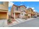 Two story house with tan exterior, balcony, attached garage, and landscaping at 4064 Emerald Wood St, Las Vegas, NV 89115