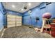 Garage with blue walls and storage at 4064 Emerald Wood St, Las Vegas, NV 89115