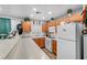 Kitchen with light wood cabinets, granite countertops, and white appliances at 4064 Emerald Wood St, Las Vegas, NV 89115