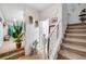 Bright entryway with staircase, tile flooring, and potted plants at 4064 Emerald Wood St, Las Vegas, NV 89115