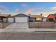 Single story home with gray siding, two car garage, and front yard at 4083 Eileen St, Las Vegas, NV 89115